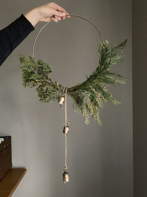 diy rustic minimal holiday wreath with foliage and gold bells